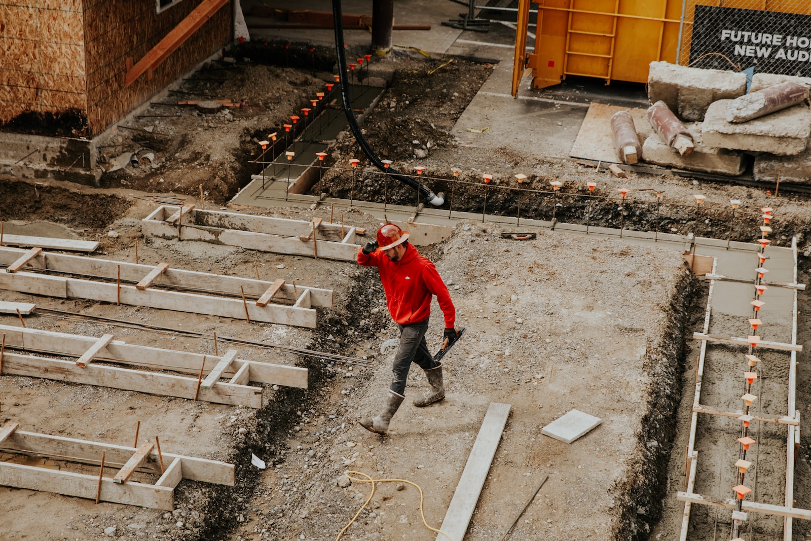 man in red jacket and black pants walking